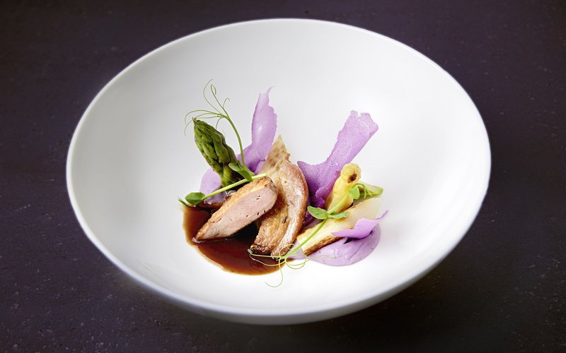 Wie es sich für ein 5-Sterne-Hotel gehört: die Angebote. Gourmetgericht mit Fleisch, grünem und weißem Spargel, lila Sauce und Garnitur