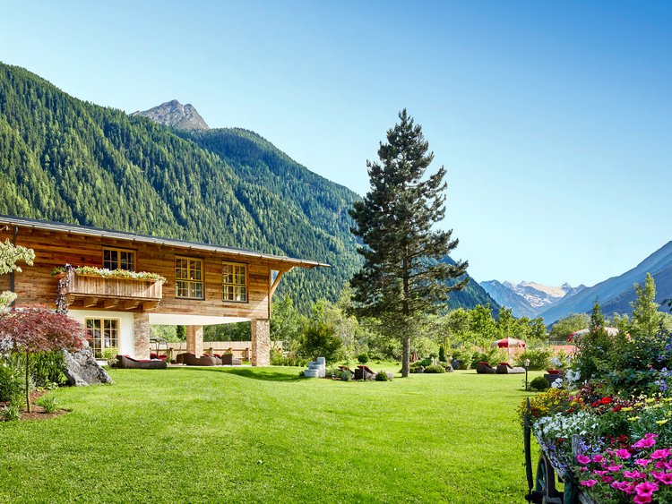 Yoga at our hotel in Tyrol Wooden chalet with garden and mountain view under clear blue sky