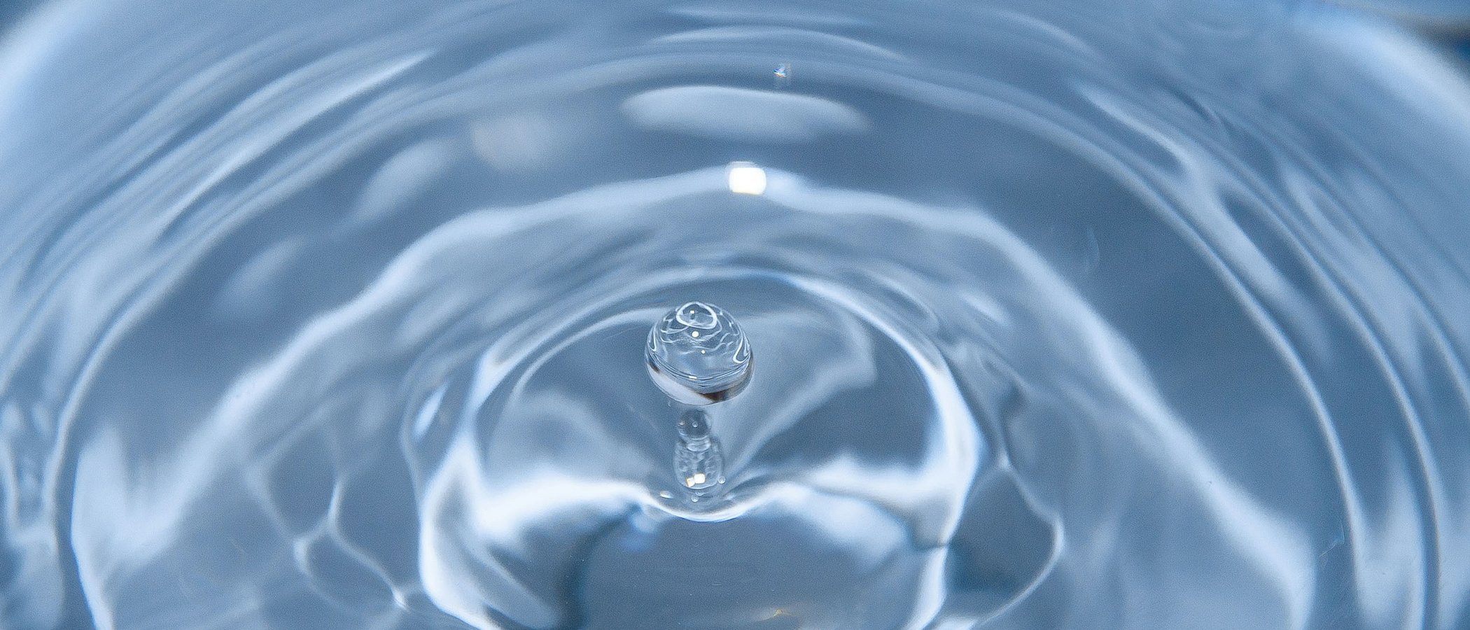 On our way to a sustainable hotel in Austria Close-up of a water droplet with concentric ripples