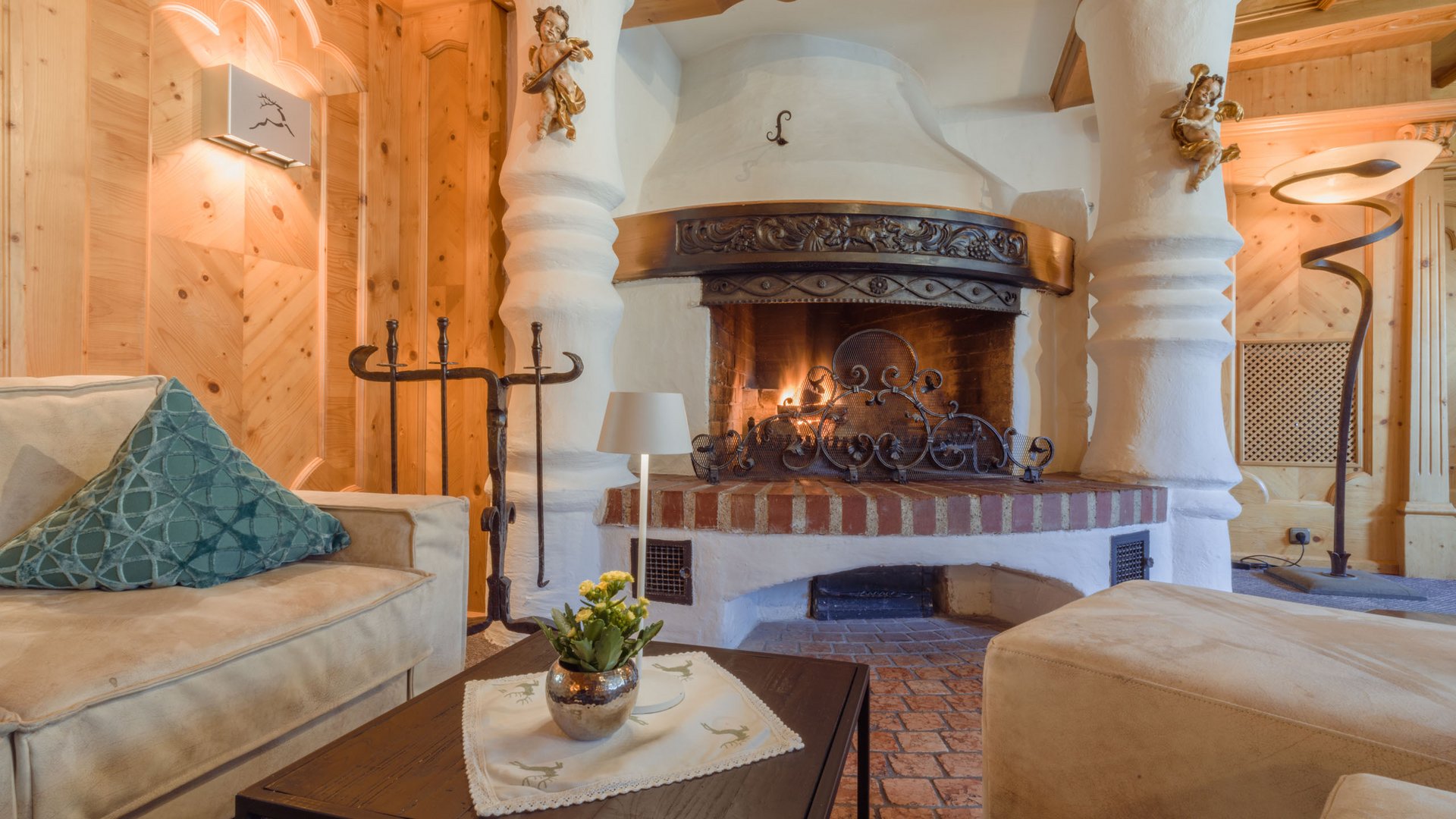 The Fireside Bar: your meeting place Cozy living room with fireplace, beige sofas, and wooden walls