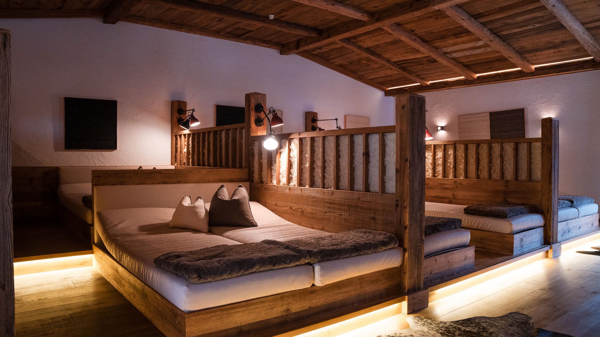 Book our 5-star hotel and enjoy these inclusive services. Cozy room with wooden beds and warm lighting